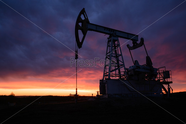 Oil pumping station at sunset