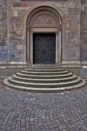 brown door closed  and stairs in a churche swisse zurich
