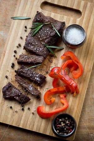 Well-done machete beef steak with grilled bell pepper, high angle view