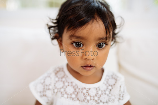 Adorable Indian little girl with her eyes wide opened
