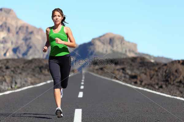 Woman running. Young girl runner jogging on a mountain trail in