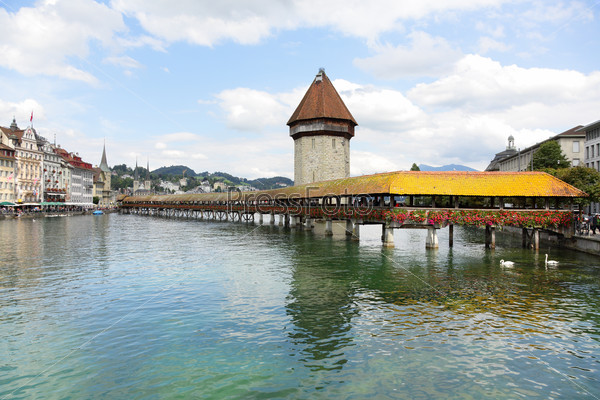 Lucerne Switzerland. Travel picture of landmark tourist attraction Kapellbrucke Chapel Bridge and Wasserturm water tower, Reuss River, Luzern.