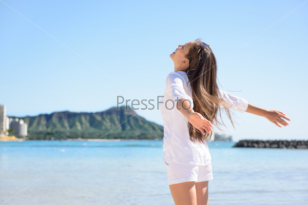 Hawaii travel hawaiian woman happy carefree in front of Honolulu Diamond Head mountain and Waikiki beach.