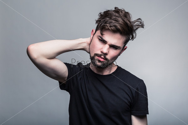 Young handsome man doubting isolated over gray background, stock photo