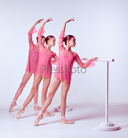Ballerinas stretching on the bar