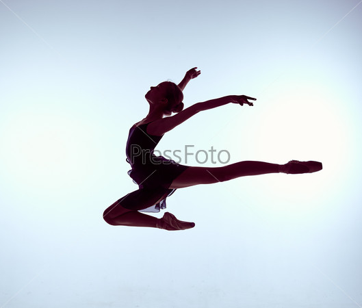 young ballet dancer jumping on a grey background. Ballerina is wearing in blue dress and pointe shoes. The outline shooting - silhouette of girl