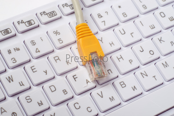 Computer keyboard with yellow cable, close up view