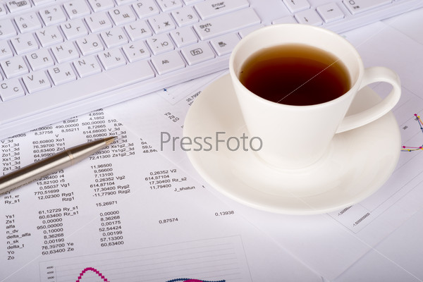 White keyboard with coffee cup and documents
