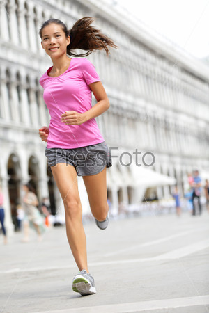 Running runner woman jogging in Venice. Female sport athlete mixed race Asian Caucasian woman training on travel vacation as tourist on Piazza San Marco Square, Venice, Italy, Europe.