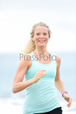 Jogging woman running woman outside on beach Female fitness\
runner girl jogger training outdoors listening to music in\
earphones Beautiful young blonde woman in her 20s