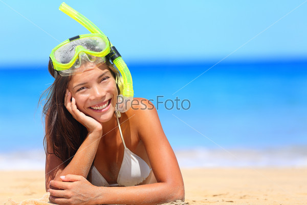 Woman on beach vacation holidays with snorkel