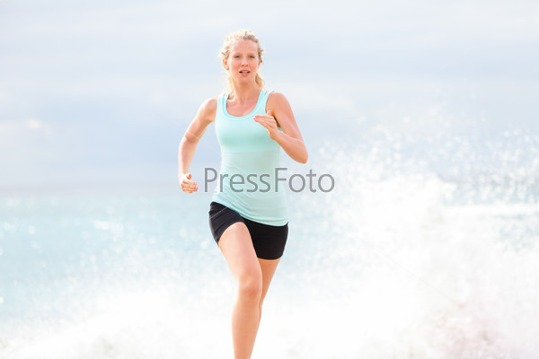 Running woman athlete jogging on beach