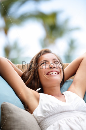 Sofa Woman relaxing enjoying lifestyle in luxury outdoor day dreaming and thinking looking happy up smiling cheerful. Beautiful young multicultural Asian Caucasian female model in her 20s.