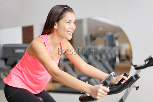 . Fit female model working out training indoor in fitness center.