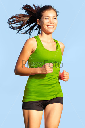 Running woman. Happy, young and athletic female fitness model in sports wear jogging outside.