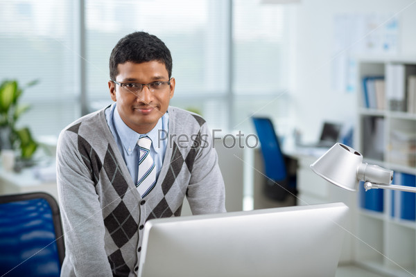 Portrait of smiling Indian office worker looking at the camera