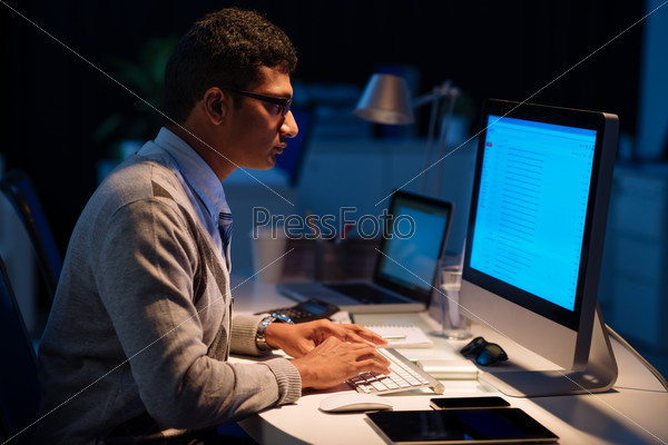 Indian manager working in the office late at night