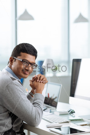Smiling Indian office worker looking at the camera