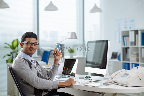 Happy Indian entrepreneur in his office