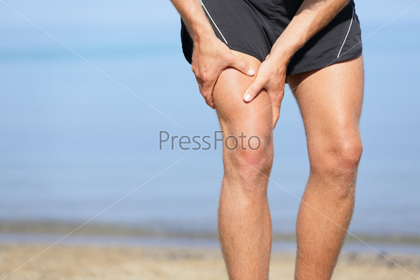 Muscle injury. Man with sprain thigh muscles. Athlete in sports..