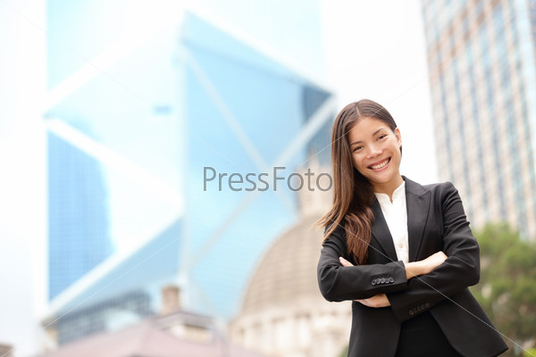 Young Asian business people business woman portrait outside. Businesswoman standing proud looking at camera in suit. Multiracial Chinese Asian / Caucasian female professional in central Hong Kong.