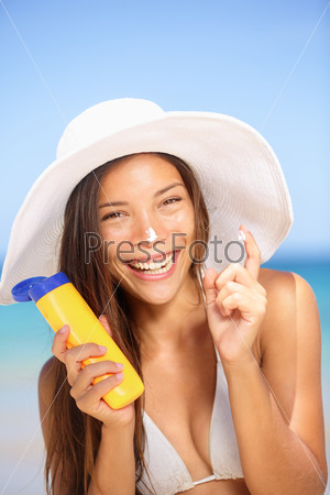 Sunscreen woman applying suntan lotion laughing