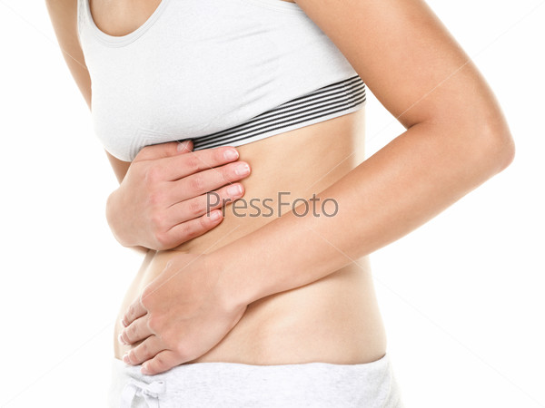 Stomach pain. Woman having abdominal pain, upset stomach or menstrual cramps. Close up of young female model isolated on white background.