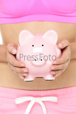 Piggy bank in front of stomach