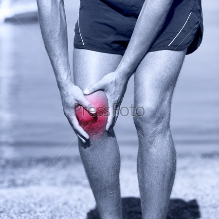 Knee Injury - sports running knee injuries on man. Male runner with pain from sprain knee. Close up of legs, muscle and knee outdoors.