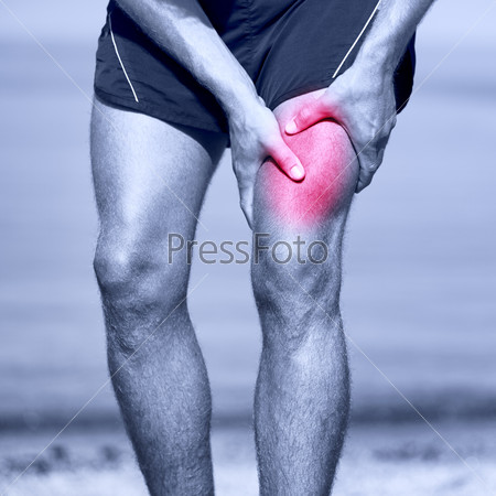 Muscle sports injury of male runner thigh. Running muscle strain injury in thigh. Closeup of runner touching leg in muscle pain.