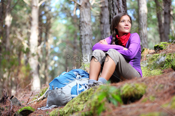 Person hiking - woman hiker sitting in forest resting during hike in beautiful forest. Orotava vally, Aguamansa, Tenerife, Canary Islands.