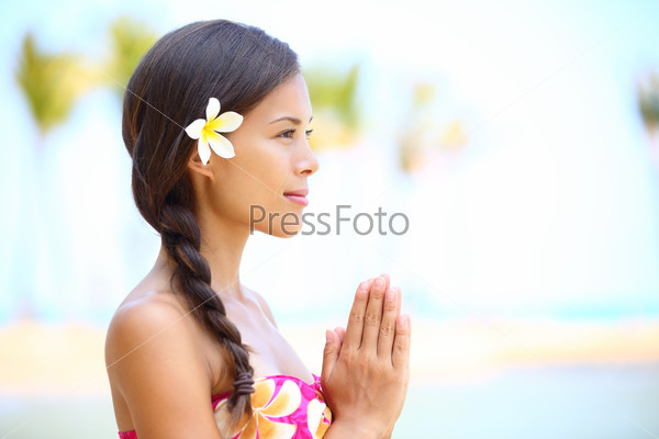 Serene meditation - meditating woman on beach