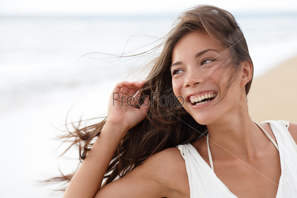 Happy girl on beach - candid young woman joyful