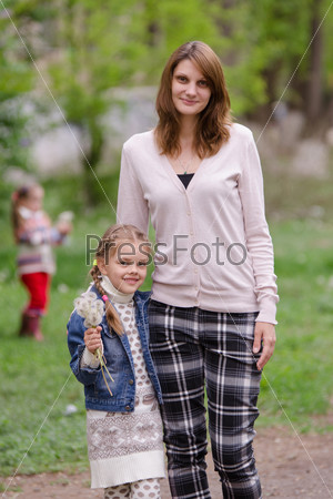 portrait of a beautiful young girl and the daughter of European type, with a bouquet of dandelions