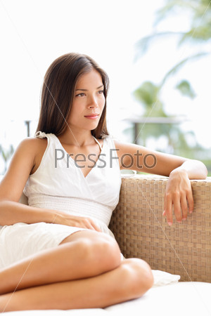 Confident serious sophisticated woman thinking and looking outdoors in luxury setting