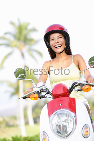 Free woman riding scooter happy