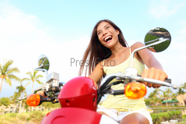 Happy free asian woman on scooter
