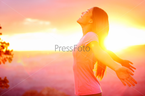 Free happy woman enjoying nature sunset. Freedom, happiness and enjoyment concept of beautiful multiracial Asian Caucasian girl in her 20s. Image from Grand Canyon, United States.