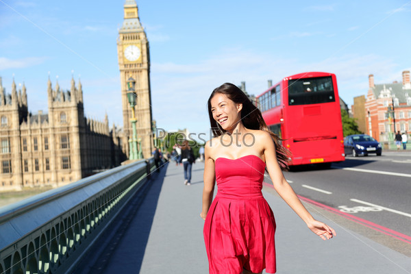 London woman happy walking by Big Ben, England