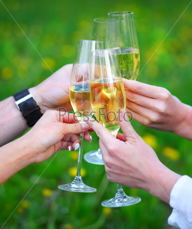 Celebration. People holding glasses of champagne making a toast outdoors