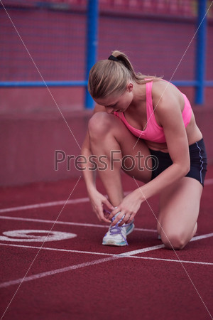 sporty woman on athletic race track