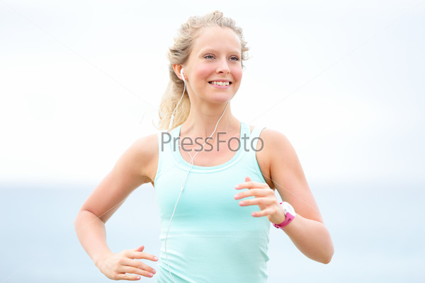 Runner woman running outdoors on beach