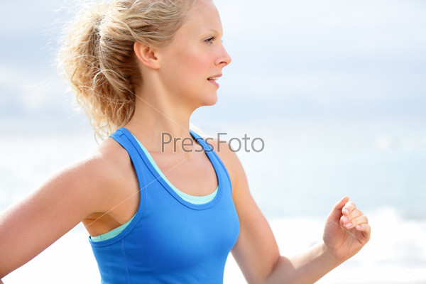 Running woman healthy lifestyle. Female runner jogging training outdoors on beach. Happy fit jogger living healthy lifestyle training outside.