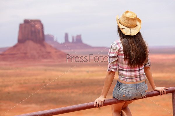 Cowgirl woman enjoying view of Monument Valley