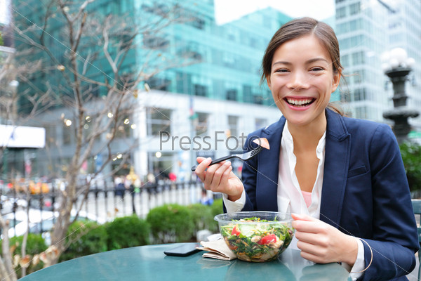 Business woman eating salad on lunch break
