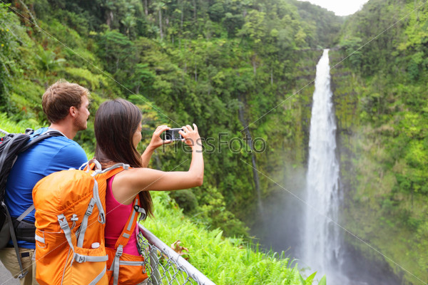 Couple tourists on Hawaii by waterfall