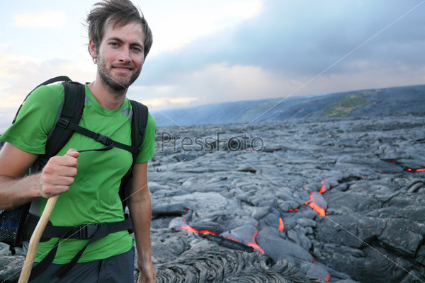 Hawaii hiker hiking by flowing lava