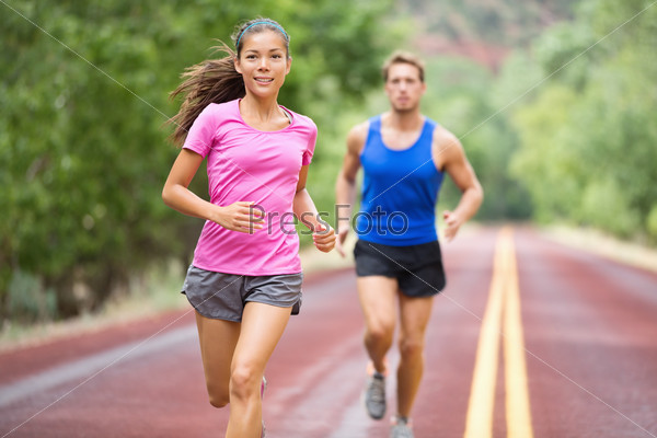 Fitness couple running training outside on road