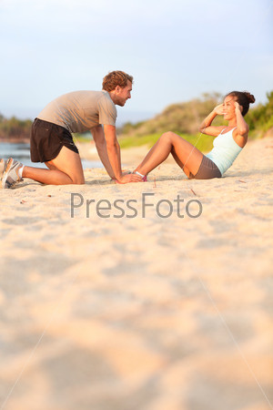 Sit ups fitness woman - male helping happy smiling