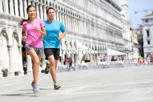 Running runner couple jogging in Venice